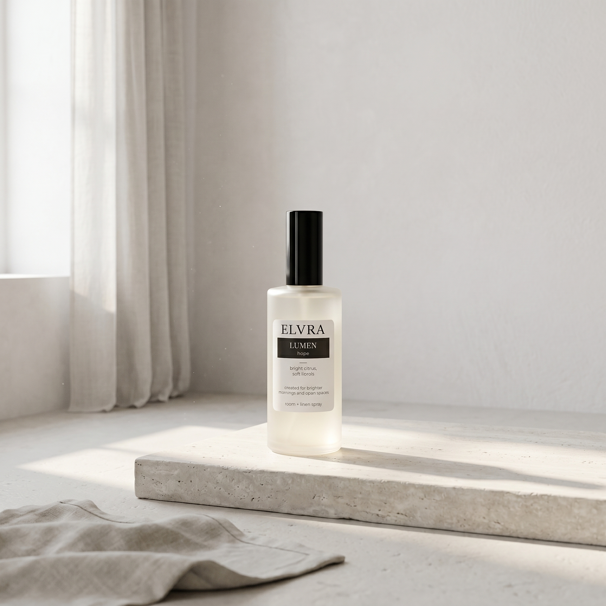 ELVRA LUMEN atmosphere mist bottle on a pale stone plinth in a sunlit, minimal white room.