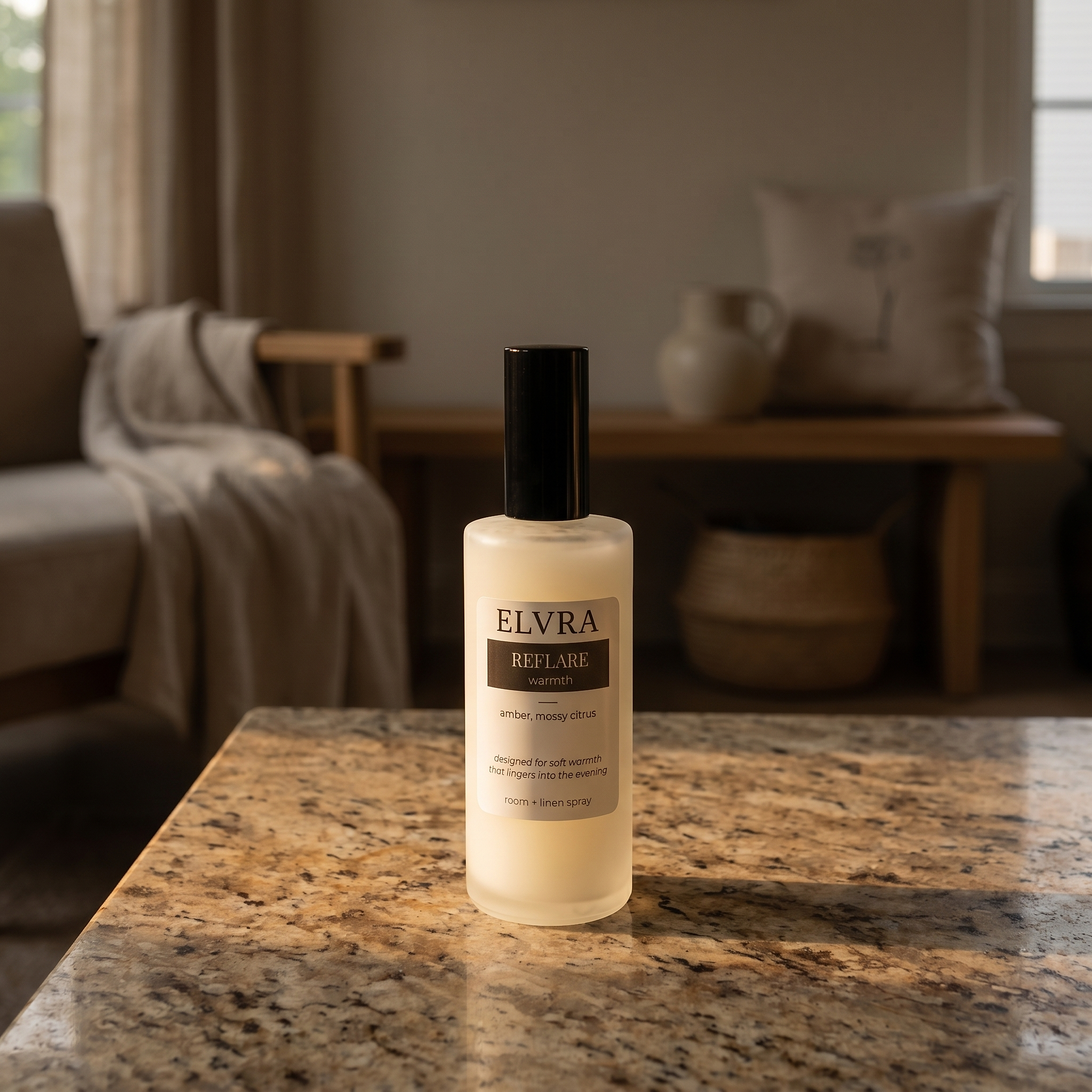 Elvra Reflare Atmosphere & Linen Mist on warm speckled stone in a softly lit, lived-in neutral interior.