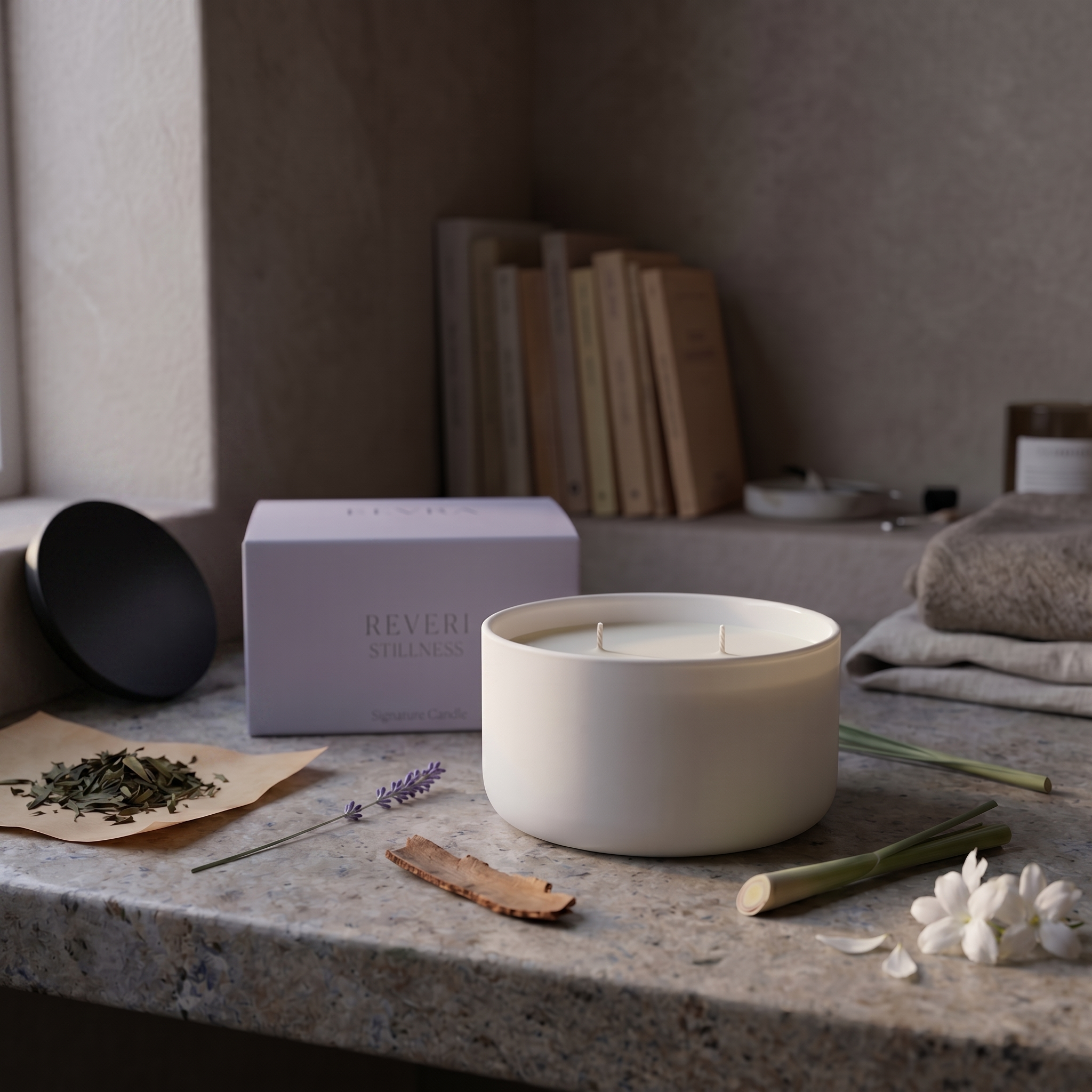 REVERI Stillness Candle with its black lid resting nearby on the stone surface, styled in a calm, editorial arrangement with soft daylight and natural shadows.