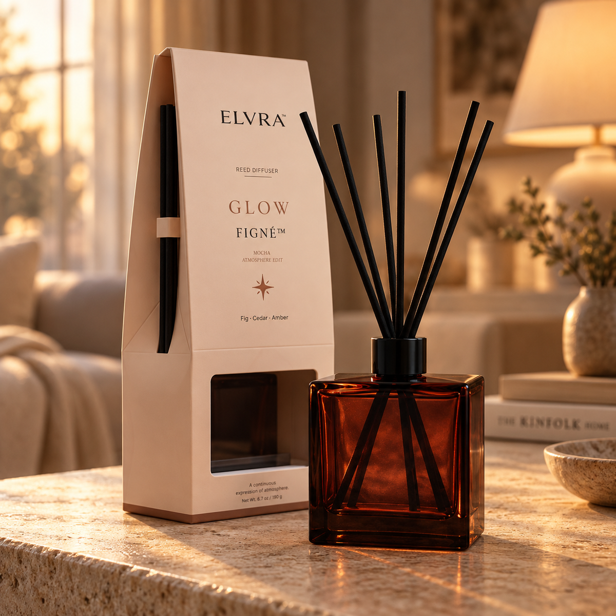 ELVRA Figné Glow reed diffuser displayed beside its pointed Mocha Atmosphere Edit packaging in a warm editorial home setting.