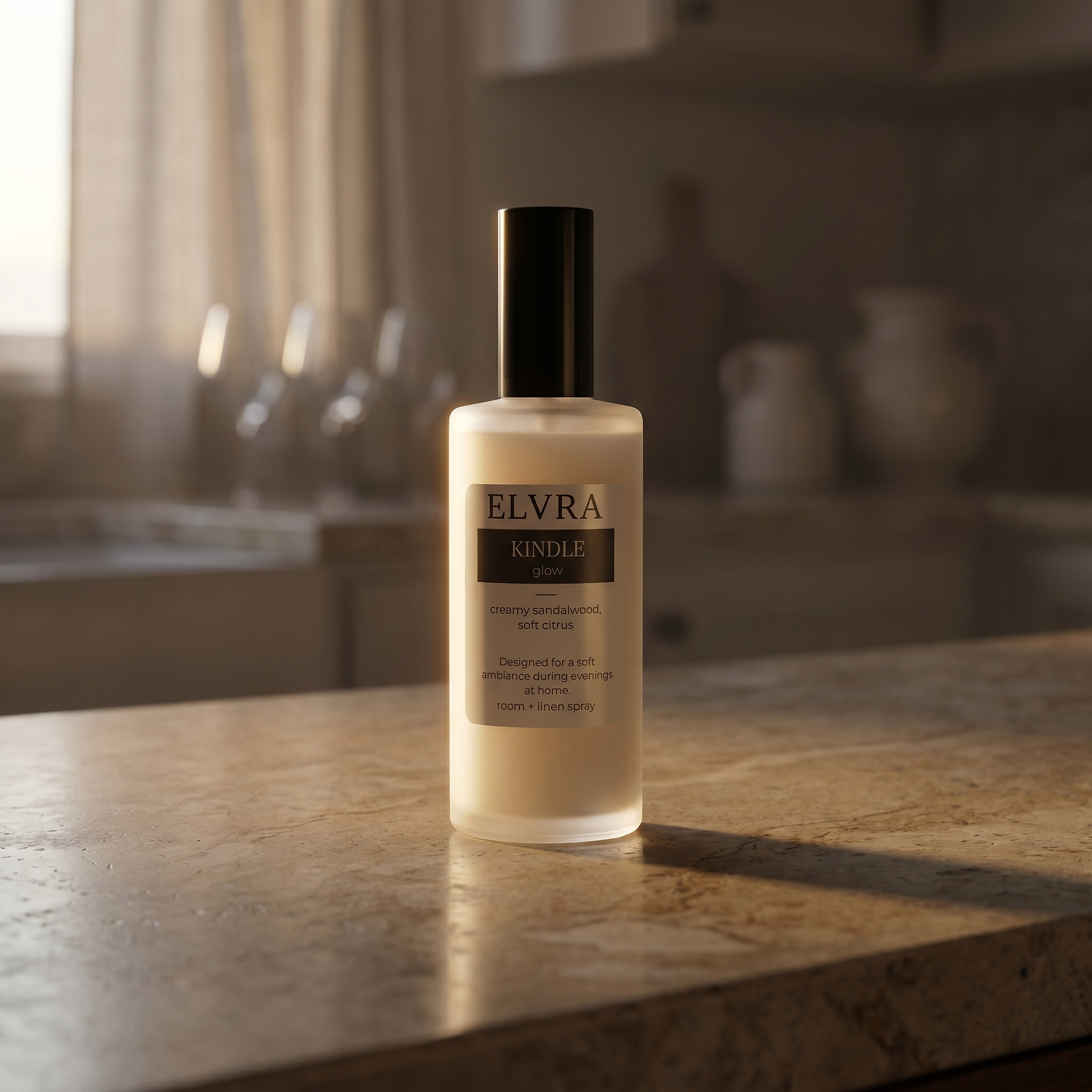 Elvra KINDLE atmosphere & Linen Mist bottle on warm stone countertop with soft sunset light and blurred kitchen background.
