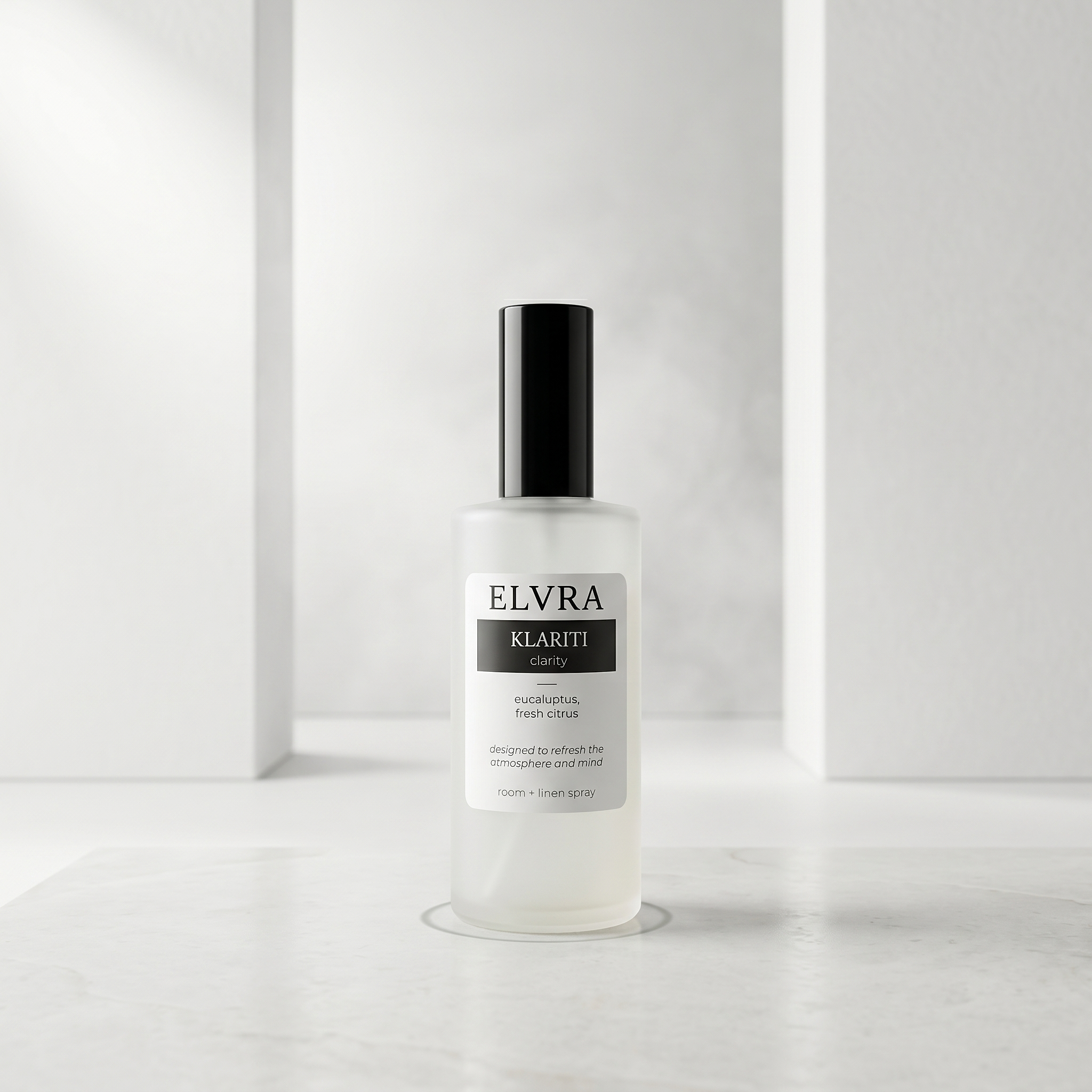 Centered frosted Elvra Klariti Atmosphere Mist bottle on a pale white studio surface with soft cool light and minimal shadows.
