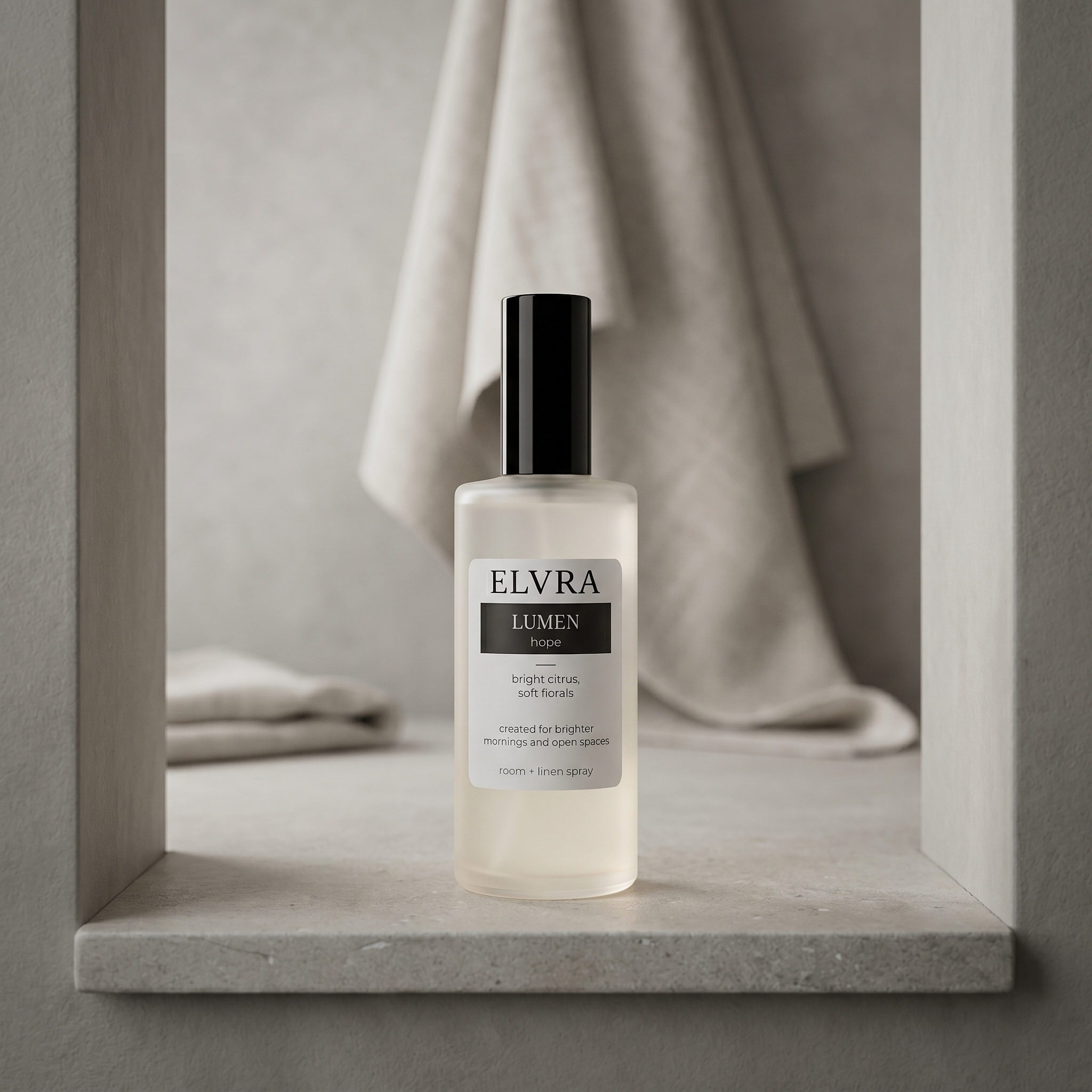 ELVRA LUMEN atmosphere room and linen mist on textured stone in a muted plaster alcove with soft linen backdrop.