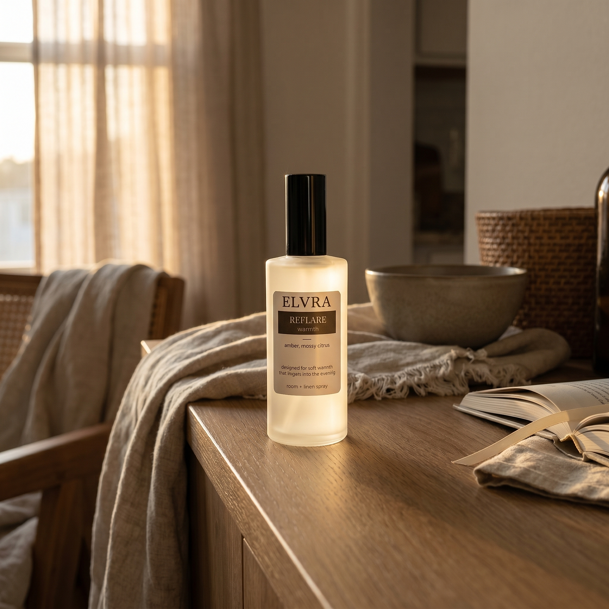 Elvra Reflare Atmosphere & Linen Mist bottle on a warm oak console with linen, ceramics, and soft evening light.