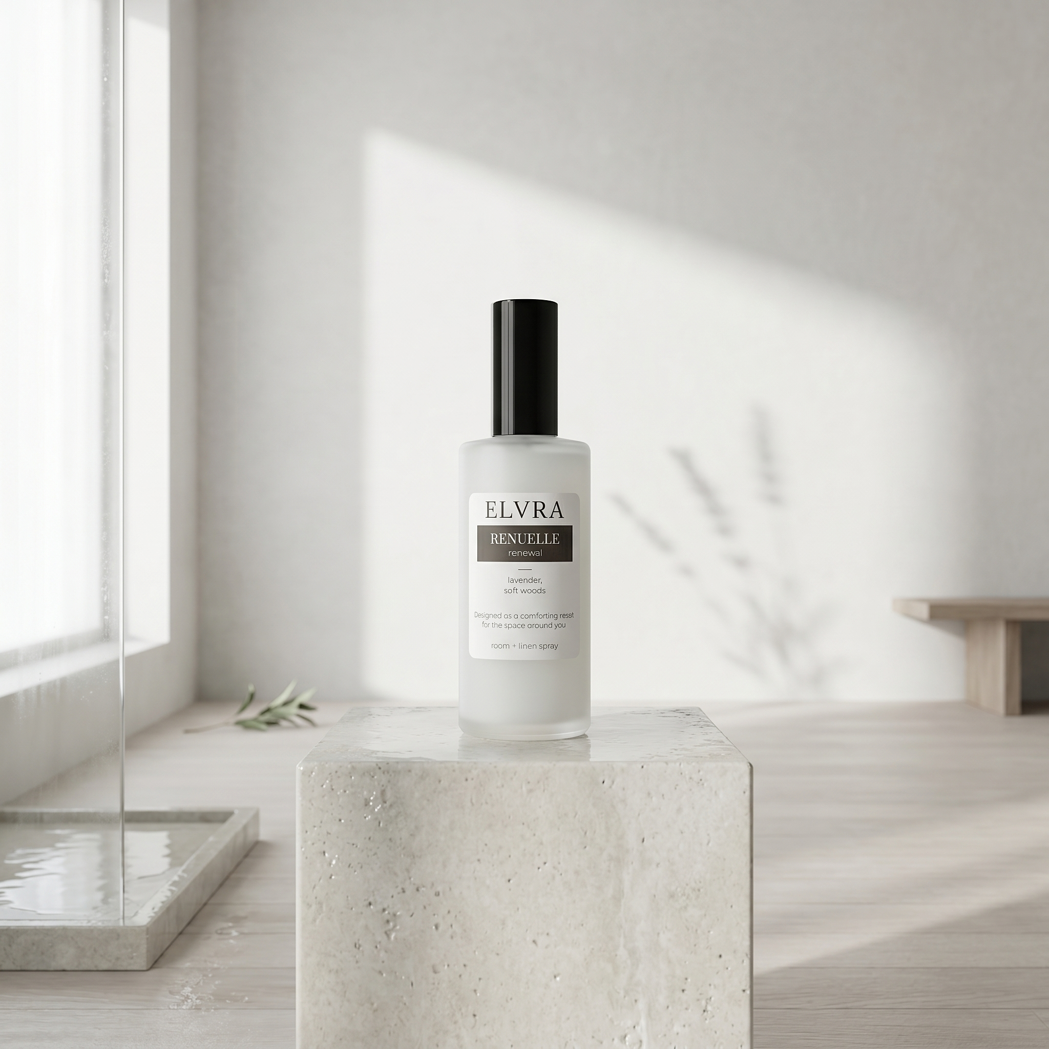 Frosted Elvra Renuelle Atmosphere mist bottle centered on pale stone plinth in a bright white room with soft botanical shadows.