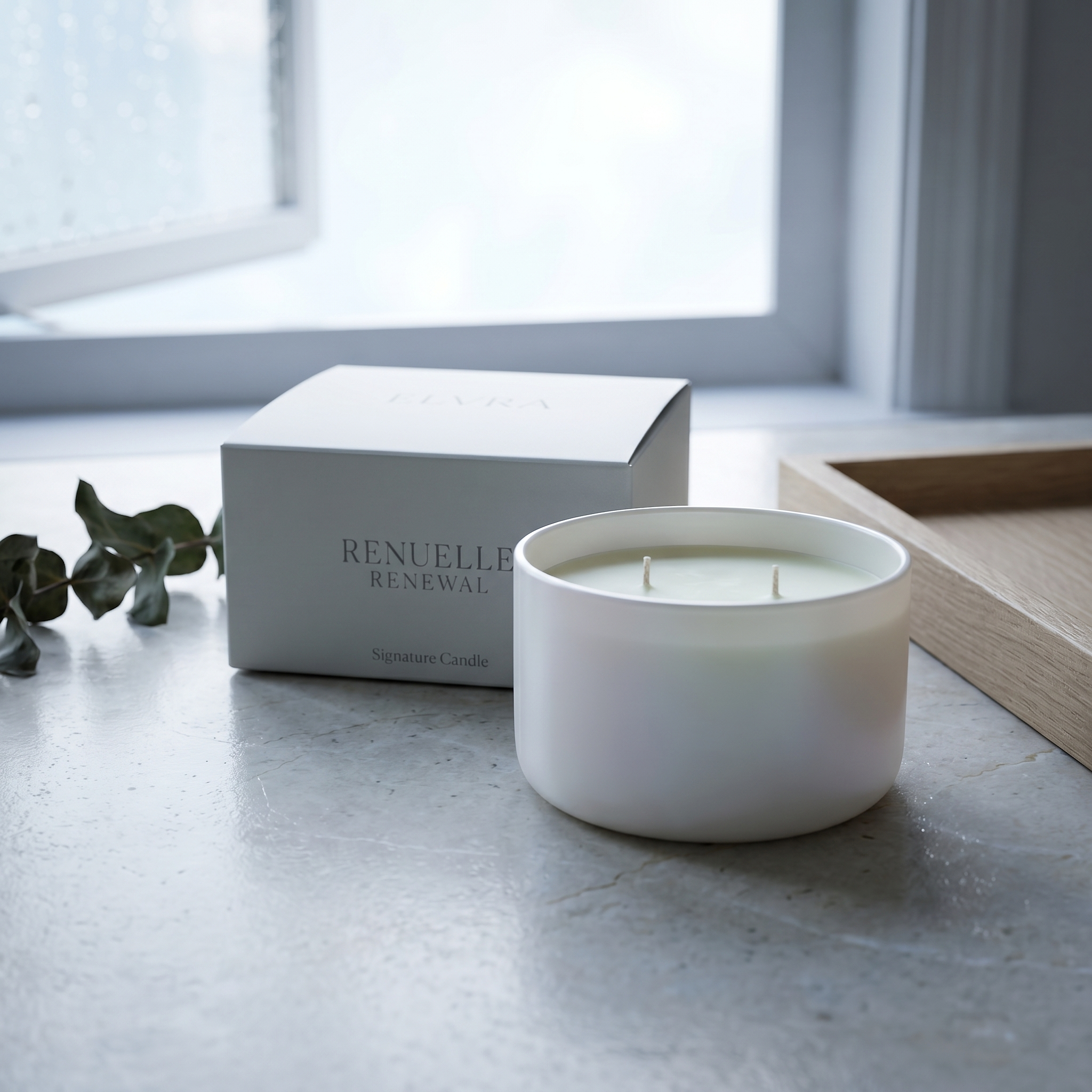 Elvra RENUELLE Candle and box on pale stone with soft daylight, blurred greenery, and a fresh after-rain atmosphere.